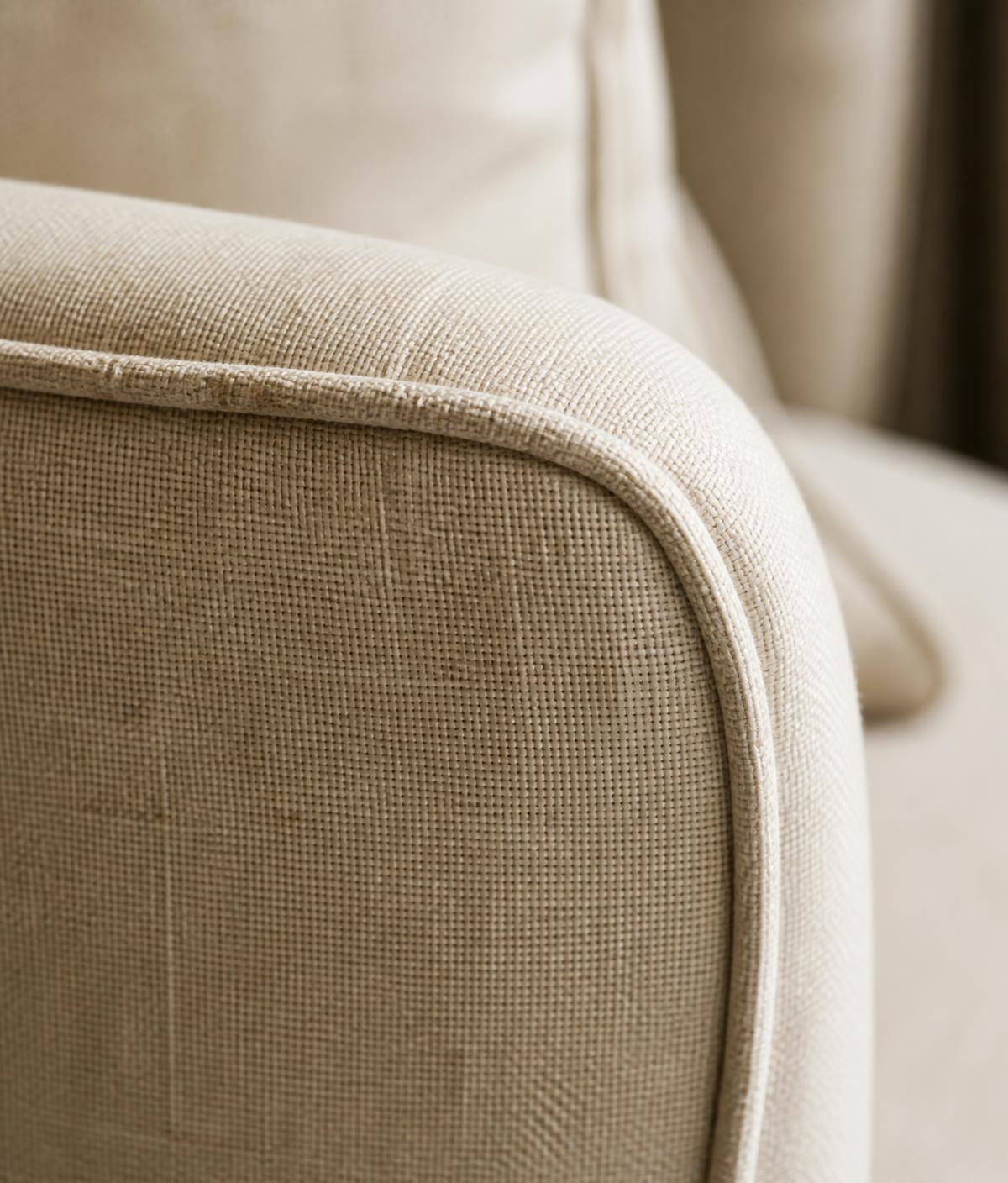Detail of hand-stitched linen upholstery on an armchair